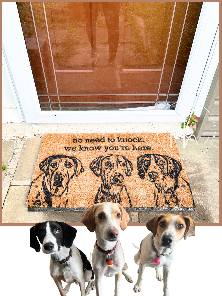 A coir front door doormat with black printed dog illustrations and the phrase 'no need to knock, we know you're here.' shown in front of a white door, with three dogs pictured below the mat on a white background.